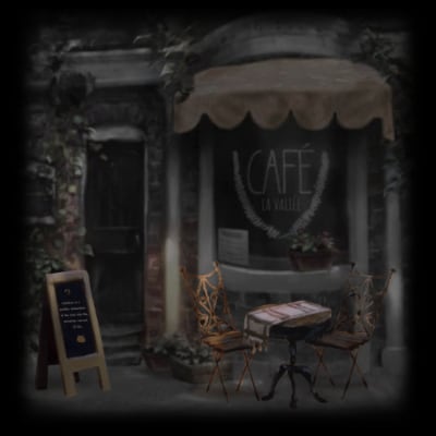 A little cafe outside with a table and chairs in front of a window. A chalkboard outside has an interesting quote